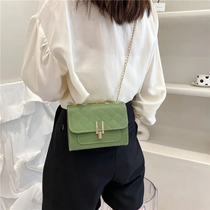 Women's white PU crossbody bag with diamond lattice texture and adjustable chain shoulder strap