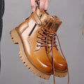 Men's light brown leather Martin boots with side zip and thick rubber sole.