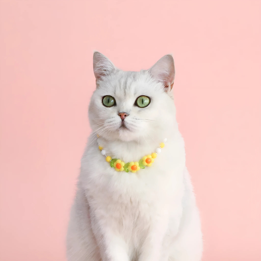 Adjustable colourful bead cat necklace in small flower, rainbow, or peach design on a white background.