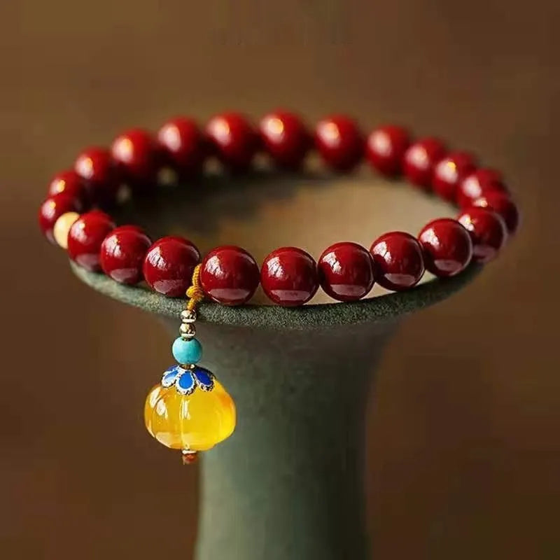 Handcrafted Chinese cinnabar bracelet with gold copper beads in wave design on wrist