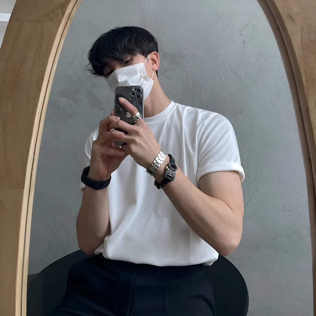 Men's slim fit cotton T-shirt in black on a hanger, showing round neck and half-sleeve design.