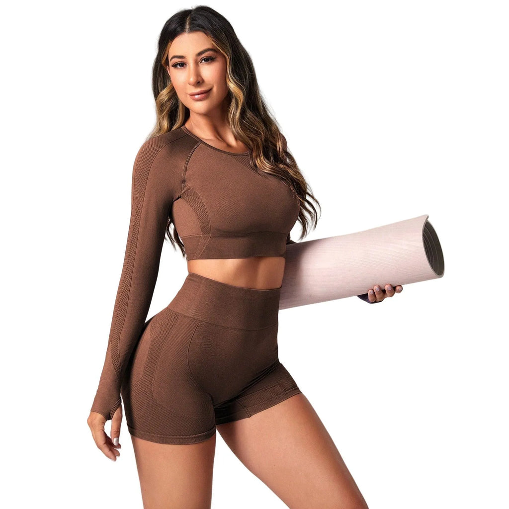 Women's black yoga suit with high waist pants and long sleeve pullover top for yoga practice