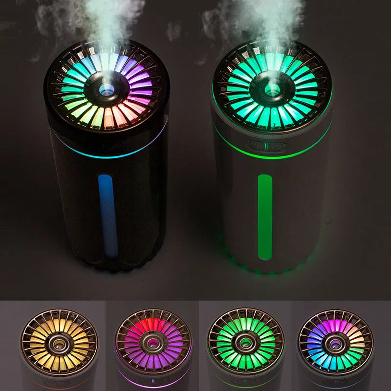 Black and white portable USB rechargeable humidifier with colourful LED lights on a car cup holder.