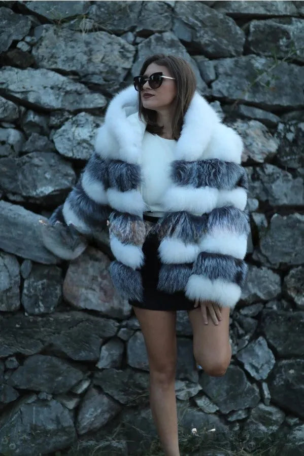 Women's loose fit hooded faux fur coat in brown on a model, showing medium length and street fashion style.