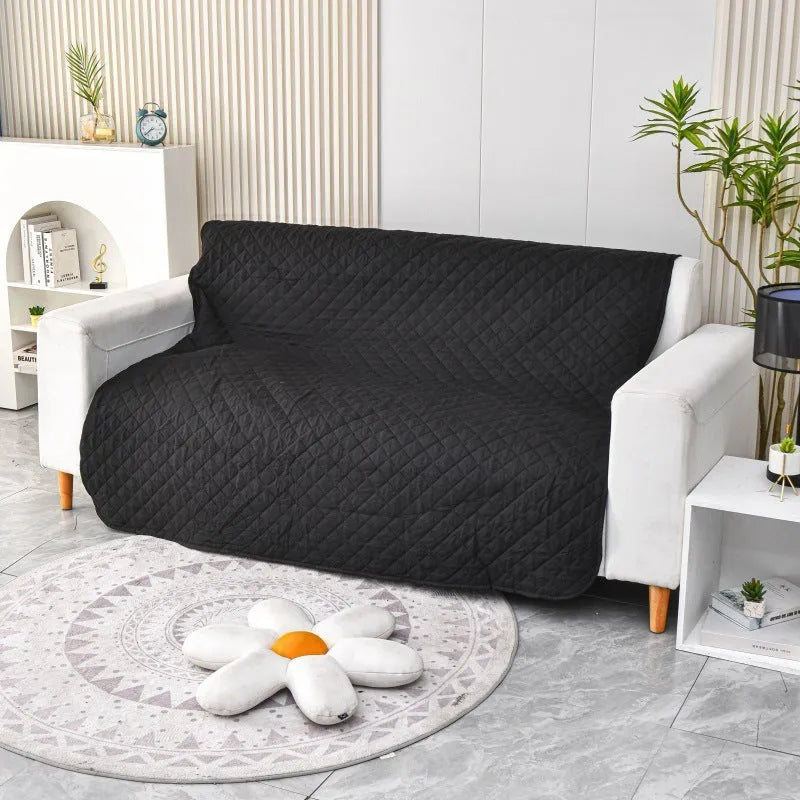 Reversible dog blanket couch cover in grey, laid flat on a sofa