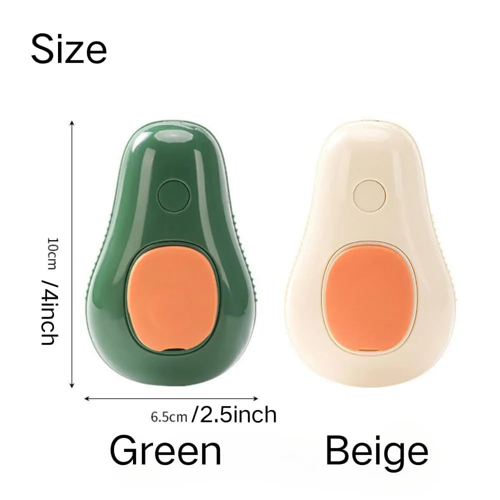 Green and white rechargeable cat steam grooming brush with silicone teeth on a wooden table.
