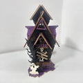 Wooden haunted house decoration with candlestick functionality measuring 14x10.5x19cm for Halloween table displays