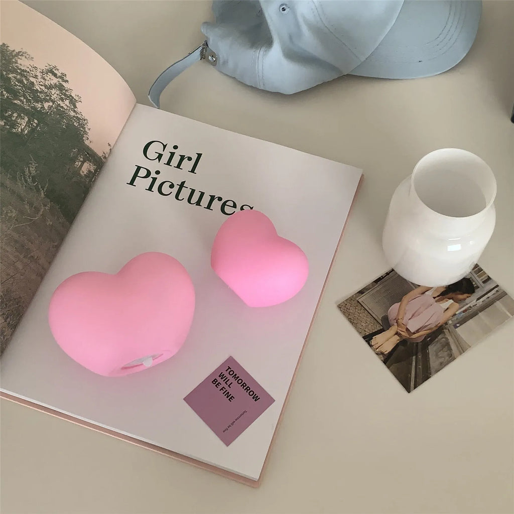Pink and white vinyl atmosphere desk lamps in small and large sizes with warm LED glow.