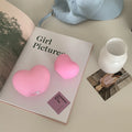 Pink and white vinyl atmosphere desk lamps in small and large sizes with warm LED glow.