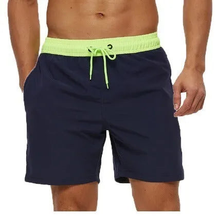 Men's blue athletic shorts with stitching waist detail, drawstring, zipper, and side pockets.