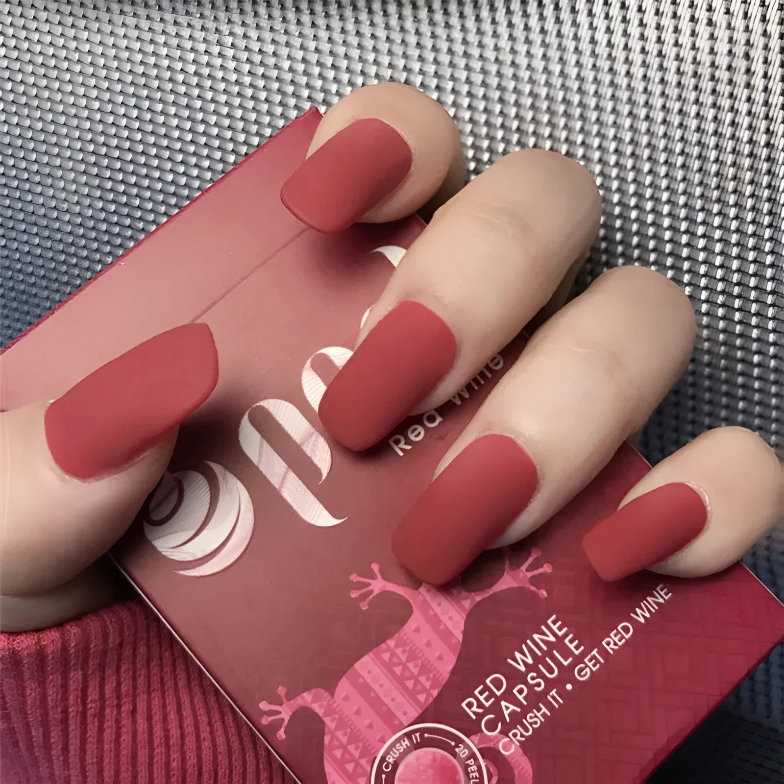24 false nails in matte red medium length with glue adhesive in packaging