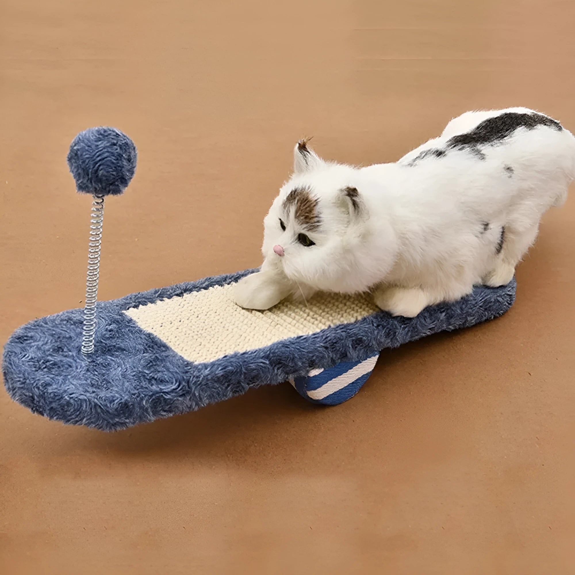 Royal blue cat seesaw toy with scratch board surface on a light background