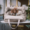 Green waterproof PU leather pet car nest bed for dogs on a car seat.
