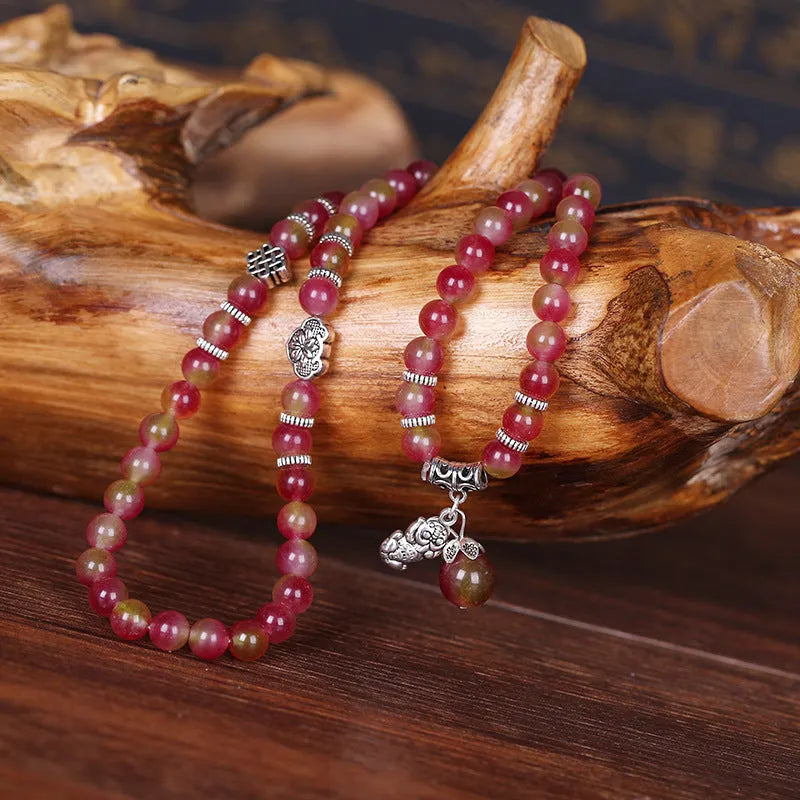 Handmade natural watermelon crystal bracelet with Chinese knots, shown in geometric national style.