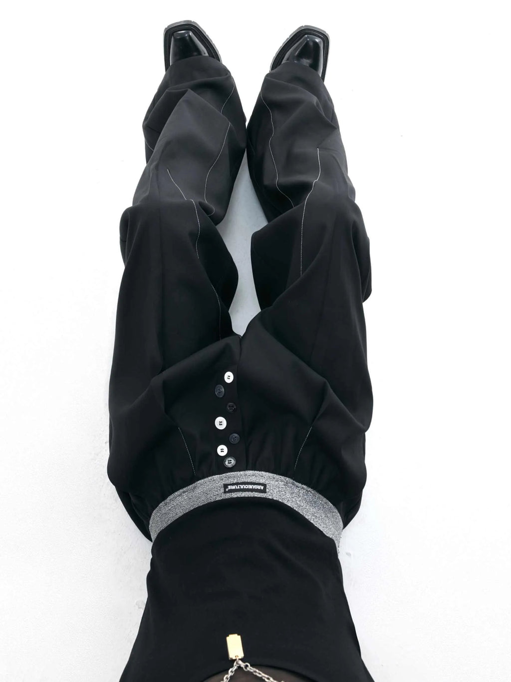 Men's high-waisted straight-leg casual trousers in black with button fly front, showing relaxed fit.