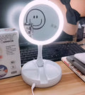 White acrylic vanity mirror with LED lights, double-sided magnification, and foldable design