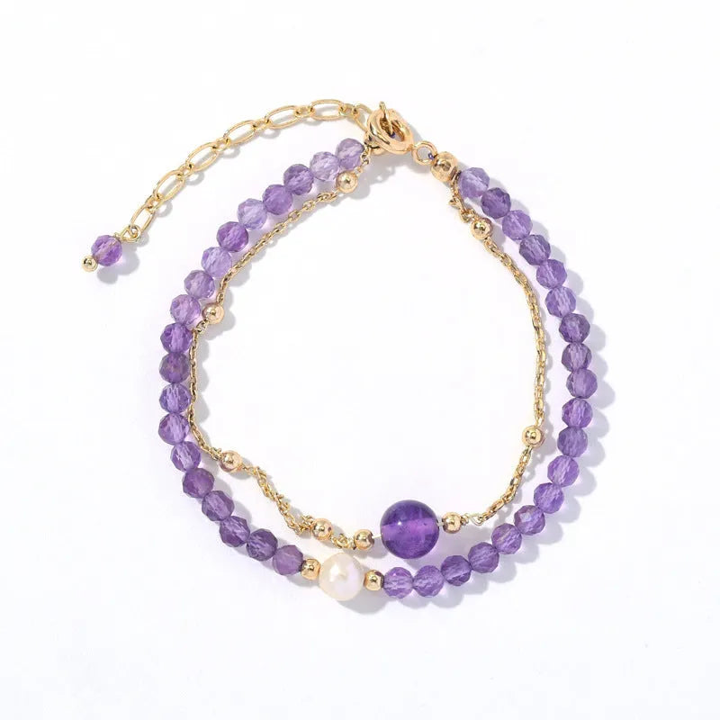Chinese style women's bracelet with electroplated metal and amethyst crystal stones cut in diamond shapes.