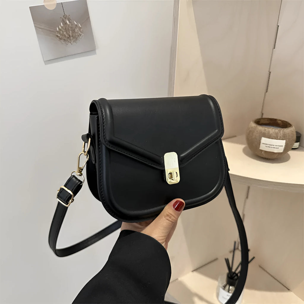 Soft black PU messenger bag with clamshell opening and niche texture, shown open.