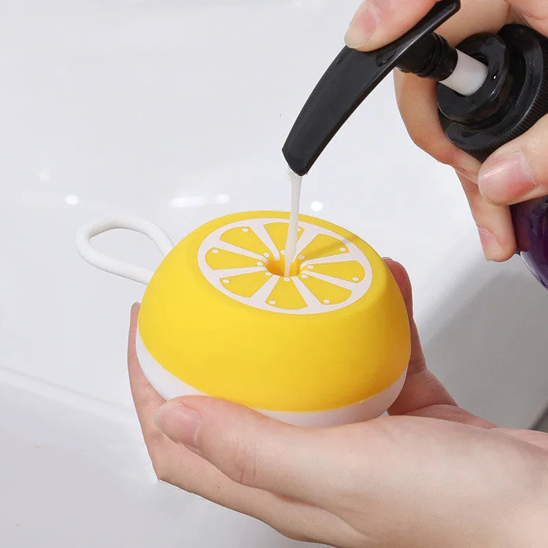 Yellow silicone pet bath brush with massage head design on wooden surface