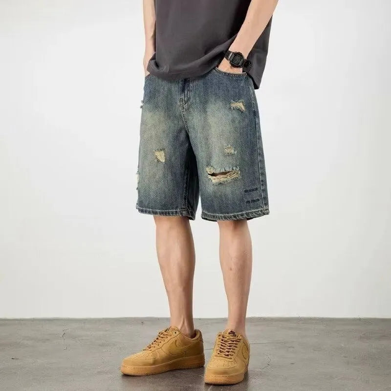 Blue retro loose hole denim shorts for men on a white background