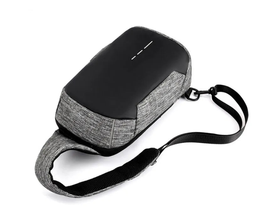 Small square dark blue Oxford cloth chest bag with a single strap and zipper, shown worn across the chest.