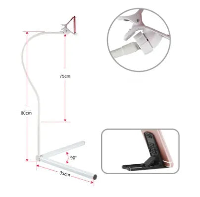 Black bedside mobile phone holder mounted on a bed frame with a phone securely clipped in place.