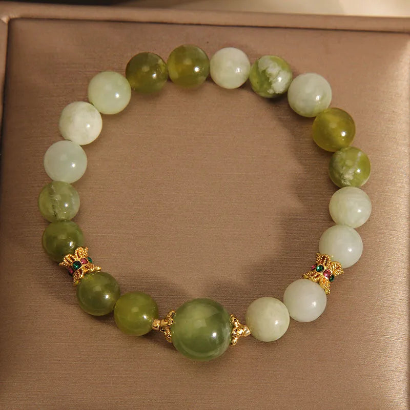 Original design women's bracelet made from green Xiuyan jade in a sweet mori style.