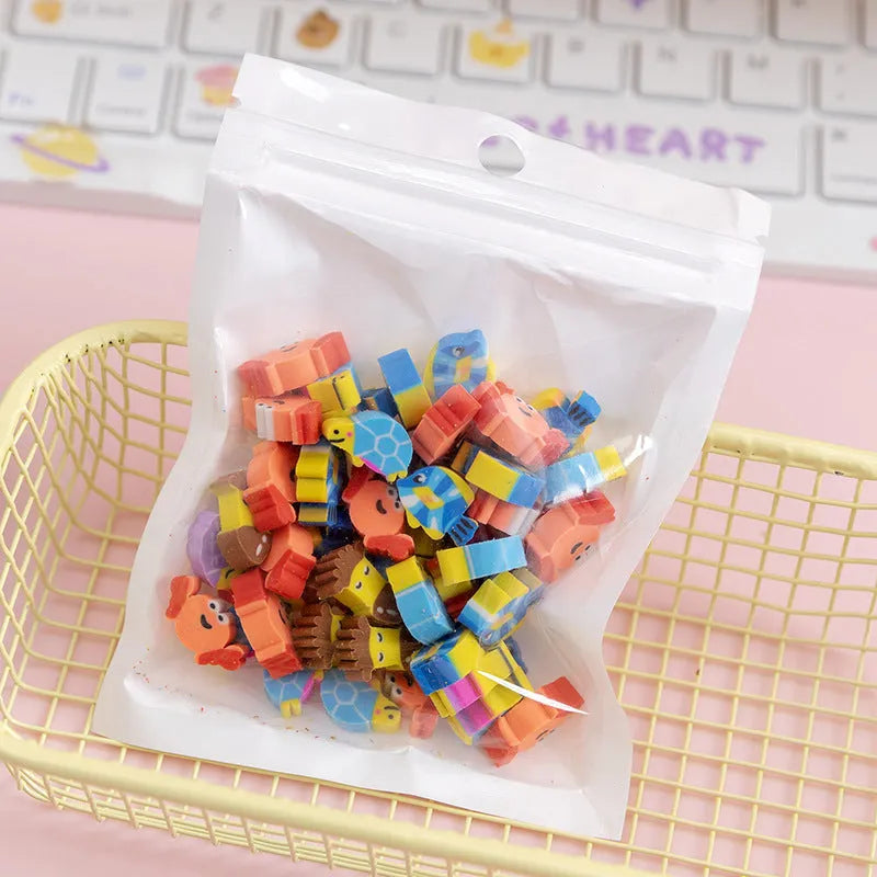 Assortment of fifty small cartoon-shaped rubber erasers in fruit and animal designs.