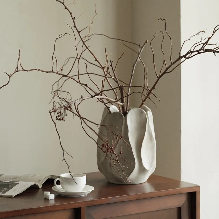 Irregular art ceramic vase in magnesium clay material displayed in high and low style options