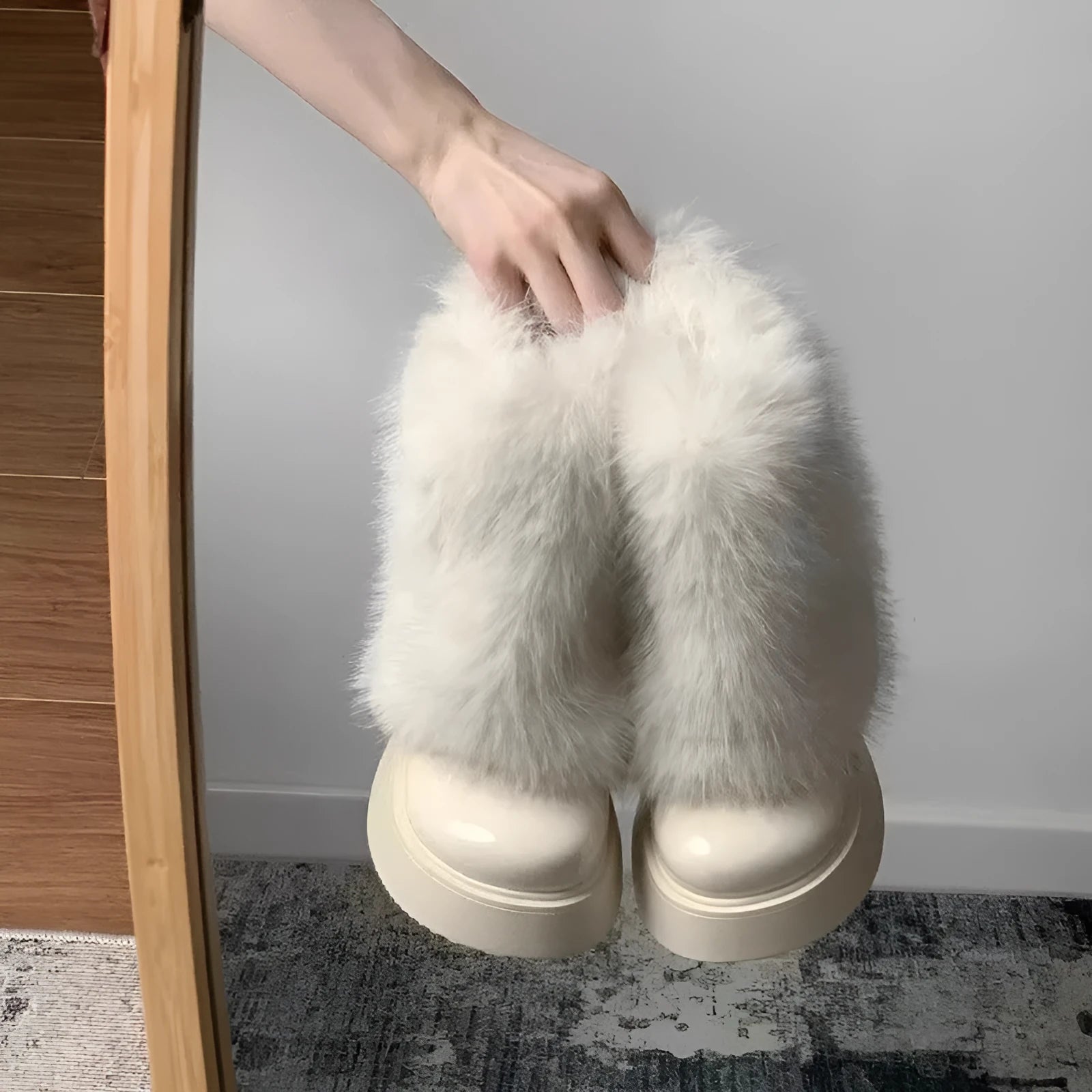 Women's black fleece-lined low-top snow boots with a round toe, waterproof platform, and a mid-height heel on a rubber sole.