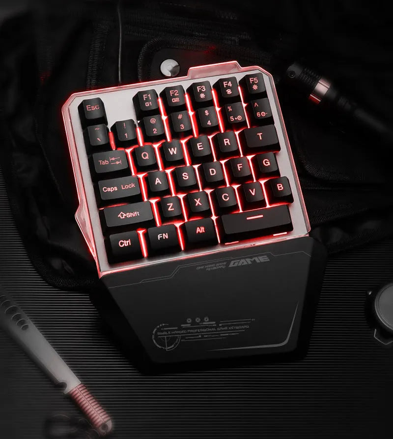 Black robotic one-handed gaming keyboard with RGB backlighting and USB cable