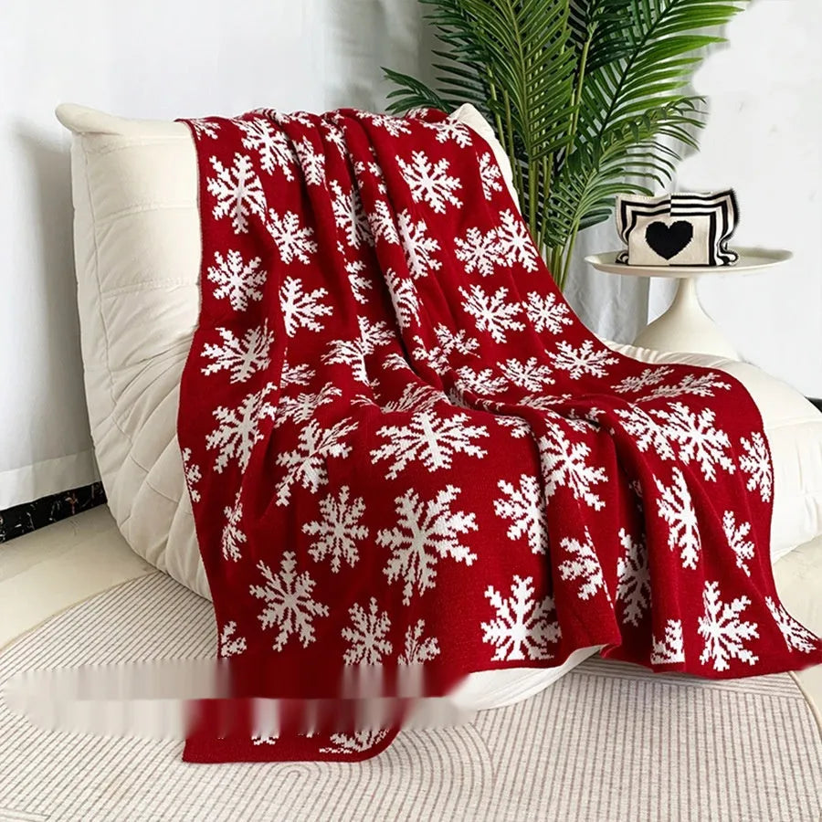 Christmas blanket with cartoon snowflake design in red and white colours