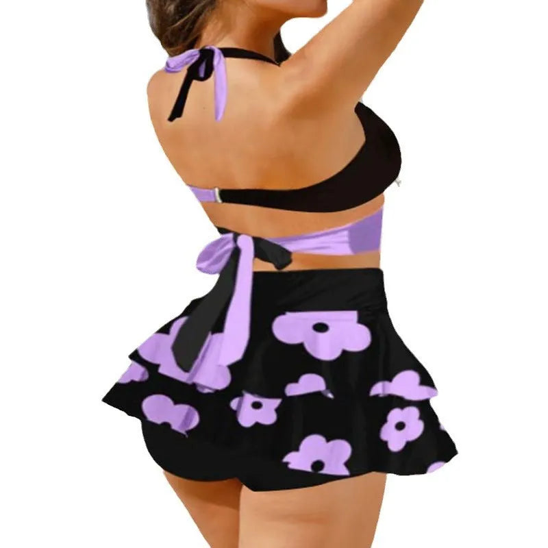 Women's purple high waist lace-up bikini swimsuit set with matching skirt on a white background.