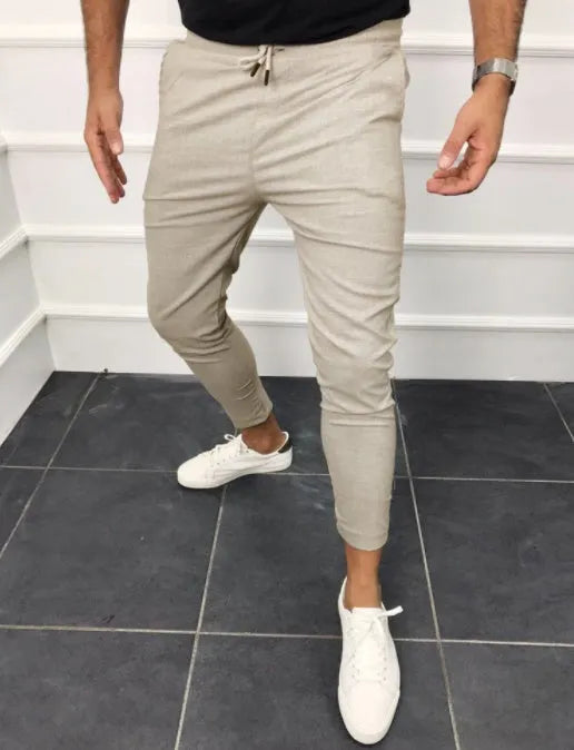 Lace-up casual jogging pants in solid light grey, nine points length, mid-waist, with adjustable front laces