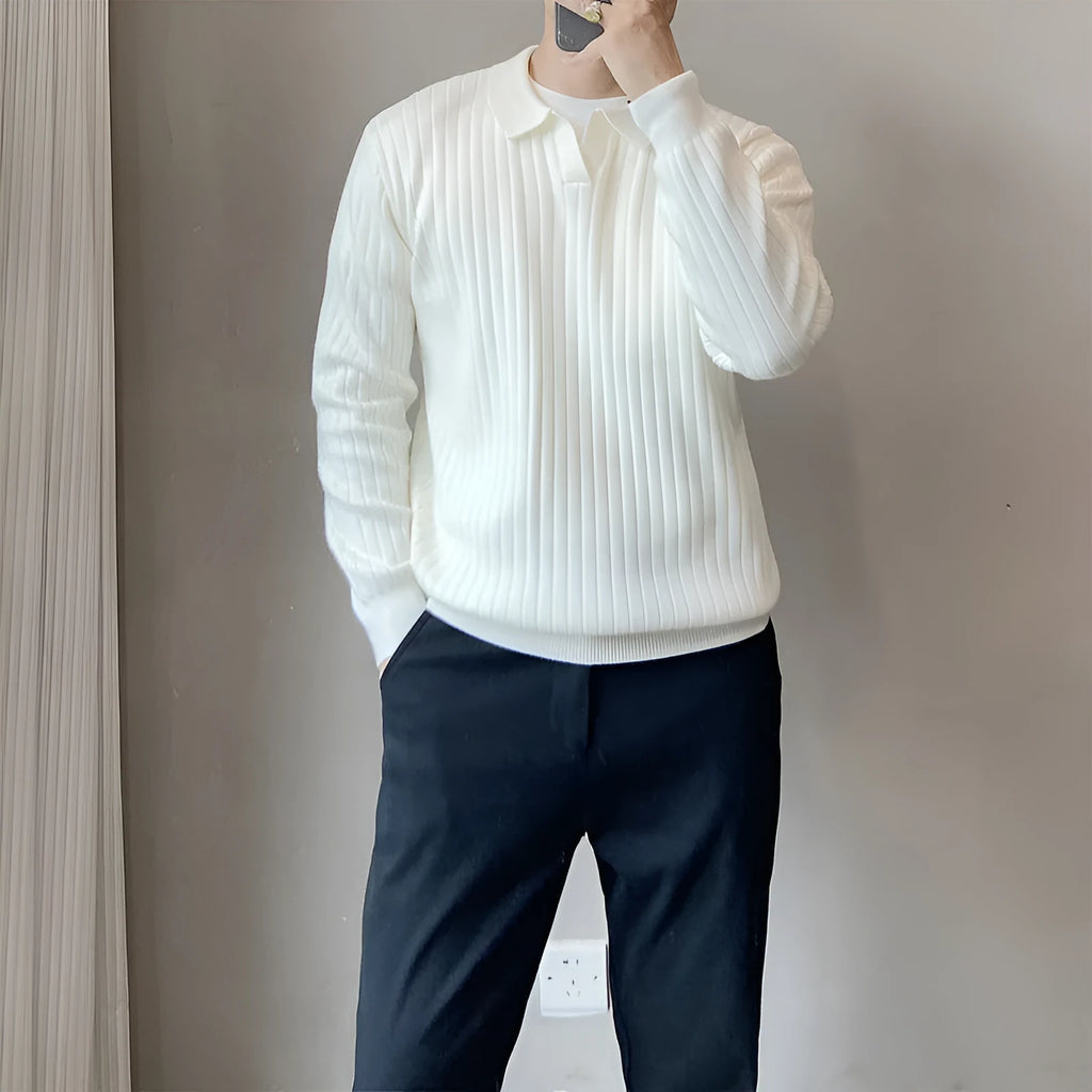 Man wearing a loose black textured knit pullover sweater with long sleeves.