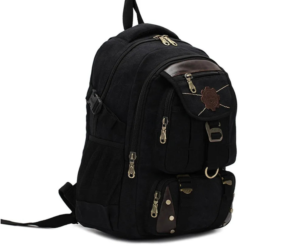 Canvas computer backpack in black with square vertical shape, zip closure, and multiple pockets