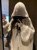 Brown women's loose-fit hooded sweater cardigan with regular sleeves on a hanger