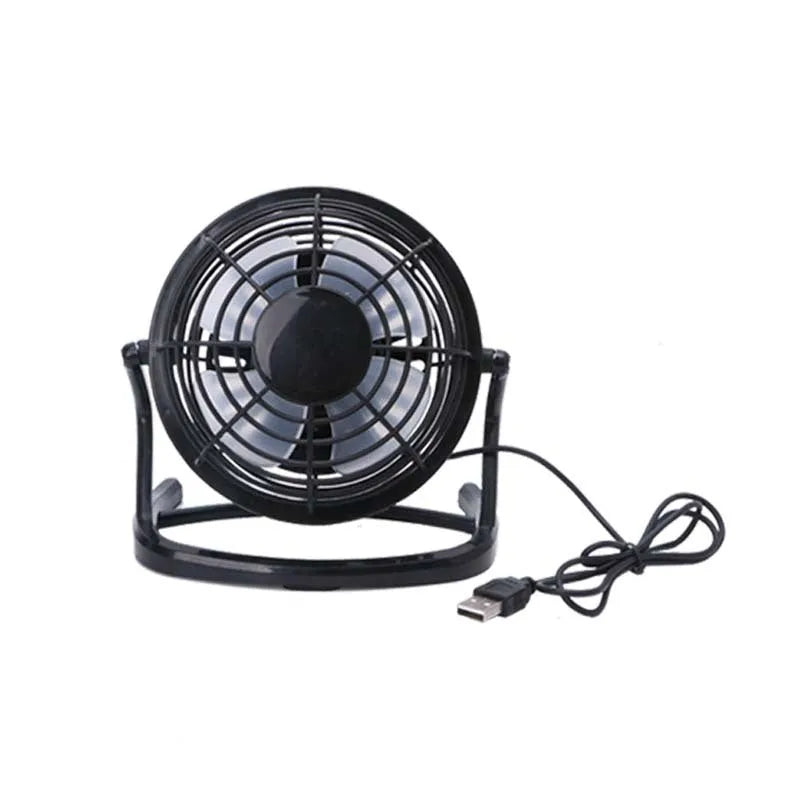 Black mini USB desktop fan with adjustable angle on wooden desk