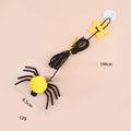 Red hanging cat toy with feather wand, bells, and spider on elastic rope, mounted on a door.
