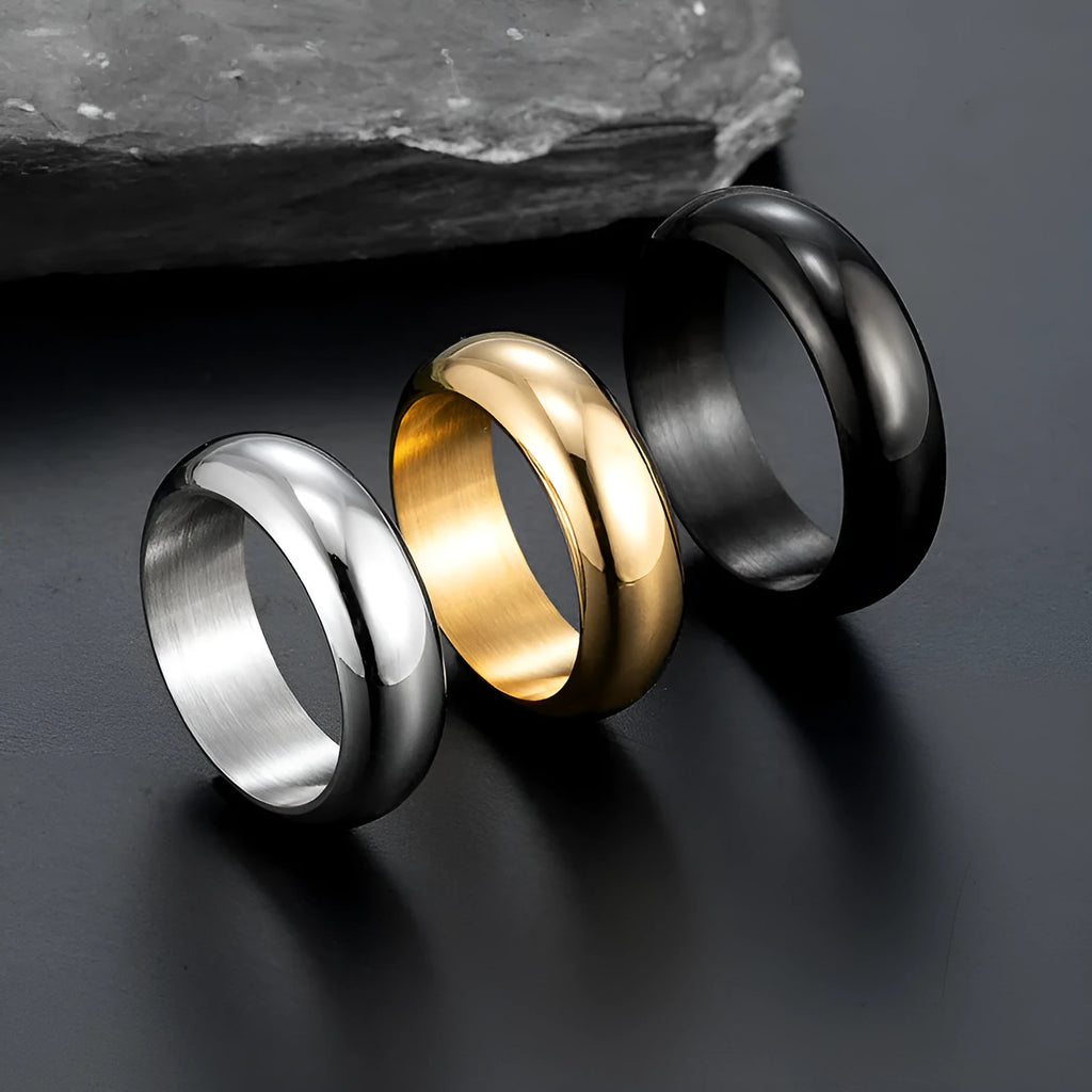 Glossy electroplated titanium steel ring shown in black, gold, and steel colour on a neutral background.