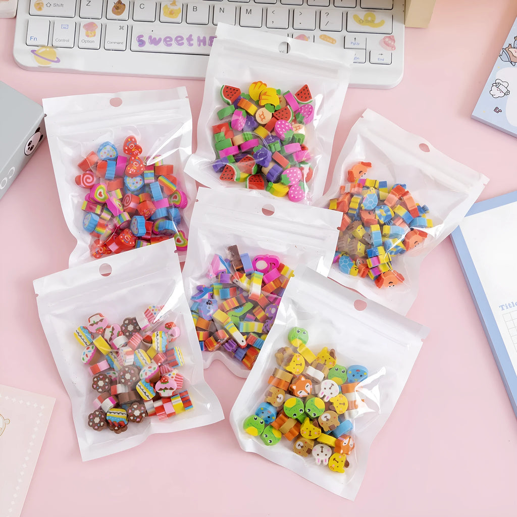 Assortment of fifty small cartoon-shaped rubber erasers in fruit and animal designs.