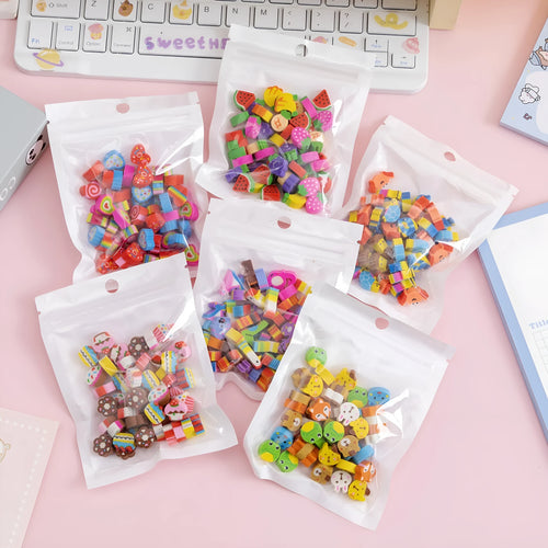 Assortment of fifty small cartoon-shaped rubber erasers in fruit and animal designs.
