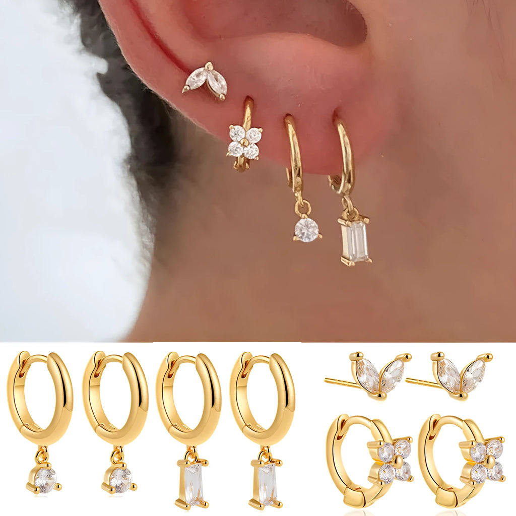 Set of four pairs of geometric copper earrings with zircon details in gold and silver colours.