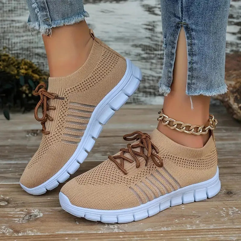 Breathable women's casual flat shoes in flying knit mesh with front lace tie.