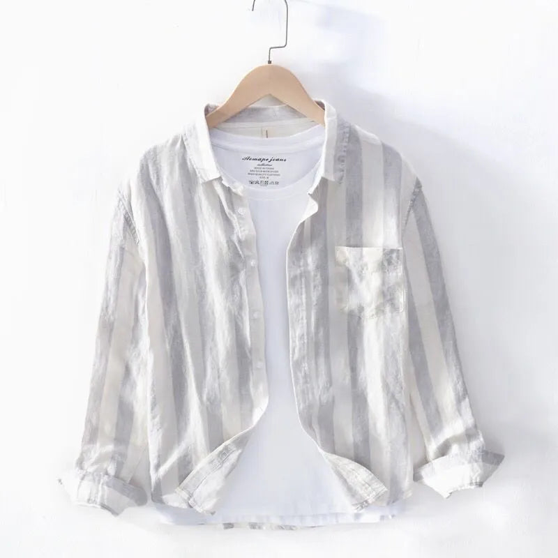 Men's blue long sleeve Hong Kong style loose fit shirt on a hanger.
