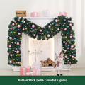 2.7 metre long pink artificial Christmas rattan vine decoration with small berries and leaves against a wall.
