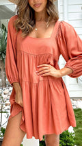 Children's orange backless pullover dress with square collar and puff sleeves showing A-line skirt silhouette