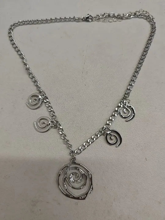 Women's spiral donut jewellery set showing necklace, bracelet and earrings in gold alloy finish