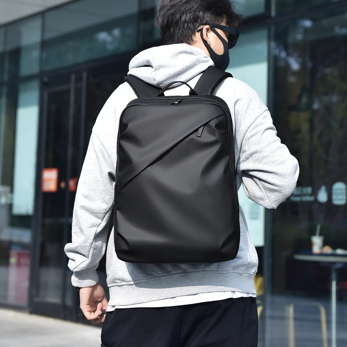 Large black waterproof backpack with 40 litre capacity and PU leather construction