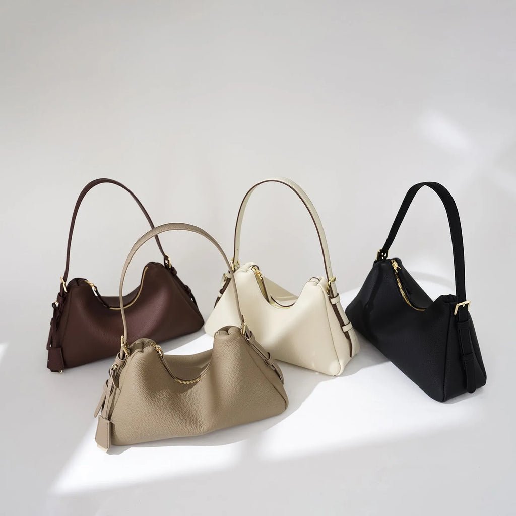 First layer cowhide leather pillow shape handbag in elephant gray with shoulder strap and open outer pocket